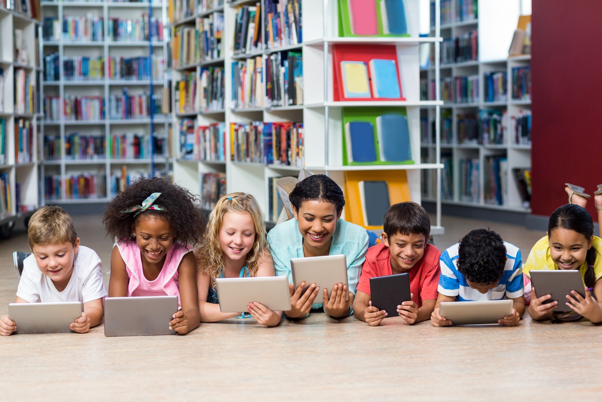 Teacher with students using digital tablet