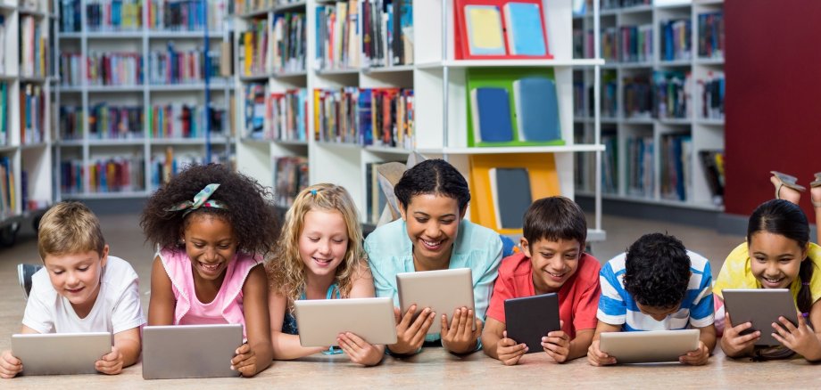 Teacher with students using digital tablet
