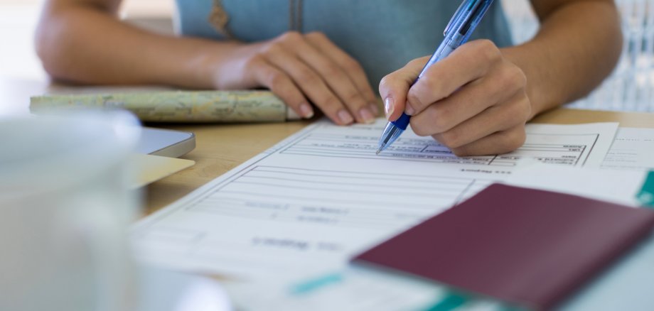 Female executive filling form at her desk