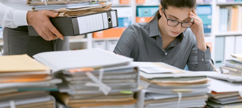 Young secretary overwhelmed by work